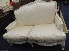 FRENCH STYLE SETTEE, having a painted wooden frame and ivory silk upholstery, 145cm (w), 80cm (d)