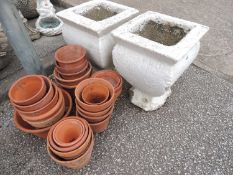PAIR OF WHITE PAINTED RECONSTITUTED STONE GARDEN URNS, and a number of terracotta plant pots