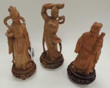 THREE CHINESE CARVED WOODEN FIGURES, mounted on later wooden bases, tallest 25cms (h)