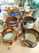 SIX VARIOUS COPPER LUSTRE JUGS Provenance: private collection Cheshire