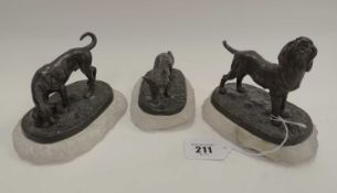 TWO BRONZE FIGURES OF SPORTING DOGS, and similar bronze figure of a crouching fox, all on white