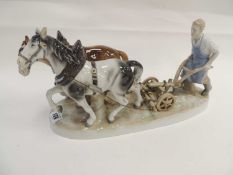 CARL SCHEIDIG PORCELAIN MODEL of a ploughman and two horses, on a naturalistic oval base, 36cms (