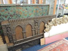 CARVED OAK PANEL and carved giltwood frieze, both once used as a headboard, and painted leather