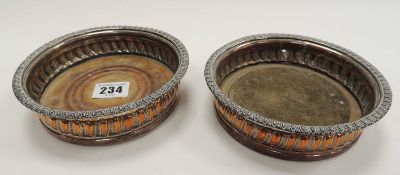PAIR OF VICTORIAN SILVER-PLATED BOTTLE COASTERS