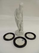 PARIAN FIGURE OF A MAIDEN, against a leafy trunk, 30cms (h), together with three circular relief