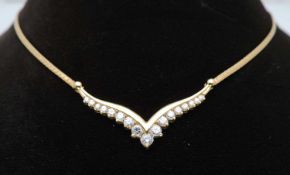 18CT GOLD DIAMOND PENDANT NECKLACE, set with seventeen graduated brilliant cut diamonds, largest 0.