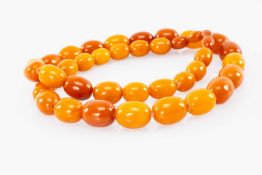 AMBER BEAD NECKLACE, the butterscotch, variously toned, oval beads from 17.7 to 10mms (diam.), 60gms