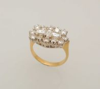 DIAMOND CLUSTER RING, centred with three baguette-cut diamonds, bordered with twelve brilliants, set
