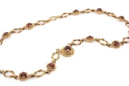 9CT GOLD GARNET NECKLACE, knot link set with thirteen garnets, 39cms long, 25.5gms in vintage Mappin