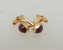 PAIR OF GOLD CUFFLINKS, set with a cabochon star ruby, unmarked, testing as 14ct, gross weight