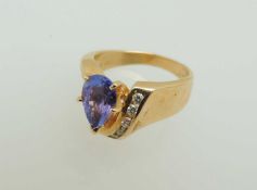 14CT GOLD TANZANITE & DIAMOND RING, pear-cut tanzanite approx. 0.75cts, flanked by channel-set
