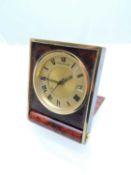 JAEGER LE-COULTRE TRAVELLING ALARM CLOCK, in a folding simulated tortoiseshell and brass case, 40