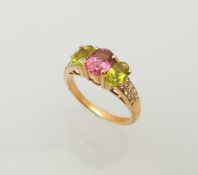 PINK GEM STONE (UNTESTED), PERIDOT & DIAMOND RING, three oval cut stones flanked by shoulders set