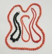 THREE ANTIQUE BEADED RED CORAL NECKLACES, largest approx. 100cms (l), the two others 52cms (l) and