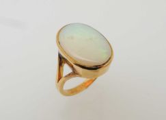 18CT GOLD OPAL RING, stone approx. 17 x 12mms, in a collet mount and split shank ring, size M, 5.