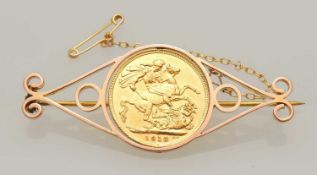 GEORGE V SOVEREIGN (drilled), mounted as a brooch in unmarked yellow metal, gross wt. 13.4g