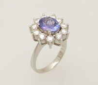 18CT WHITE GOLD TANZANITE & DIAMOND CLUSTER RING, centre with an oval cut tanzanite approx. 2.