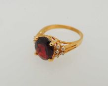 18CT GOLD GARNET & DIAMOND CLUSTER RING, oval-cut garnet approx. 10 x 8mms, bordered with ten