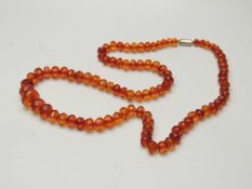 BALTIC AMBER BEADED NECKLACE, having graduated faceted beads, the largest being 19mm (diam.),