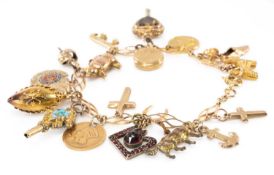 9CT GOLD CHARM BRACELET, with an assortment of 9ct and yellow metal charms including animals,