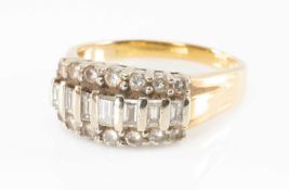 14K DIAMOND CLUSTER RING, set with row of baguette cut diamonds between brilliant cut diamond