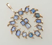 INDIAN SAPPHIRE PENDANT, heart shaped and set with sixteen variable cut stones, of variable