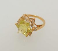 UNUSUAL 18CT GOLD STAR-CUT PERIDOT & DIAMOND RING, central stone 14mms (diam.), bordered with tiny