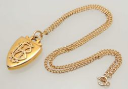 9CT GOLD CURB LINK NECKLACE, supporting a Victorian monogrammed shield-shaped picture locket,