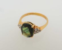 18CT GOLD GREEN TOURMALINE & DIAMOND RING, oval-cut tourmaline approx. 1ct, bordered with six