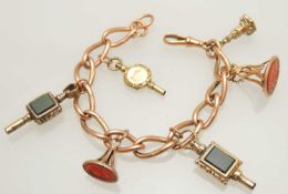 9CT GOLD CURB LINK CHARM BRACELET, supporting three unmarked yellow metal seal fobs, and three