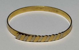 ITALIAN 18CT TWO COLOUR GOLD BANGLE, marked '750', cuff size 56cms, 15.7gms Provenance: private