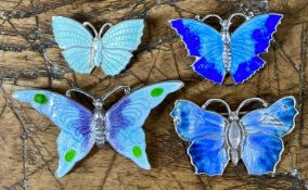 TWO ENAMELLED STERLING SILVER BUTTERFLY BROOCHES, one 45mms, the other 30mms, the larger having re-