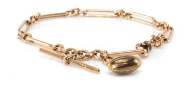 9CT GOLD TROMBONE LINK ALBERT CHAIN, with T-bar, lobster clasp and rugby ball fob, 33cms long, wt.