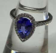 TANZANITE & DIAMOND PEAR SHAPED CLUSTER RING, central tanzanite approx. 2.10cts, bordered with
