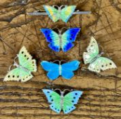 FOUR ENAMELLED SILVER BUTTERFLY BROOCHES of similar design, 30mms, marked silver, 18.9gms, a small