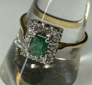 EMERALD & DIAMOND CLUSTER RING, emerald approx. 0.5cts, bordered with small round cut diamonds,