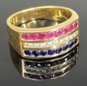 DIAMOND, RUBY & SAPPHIRE TRINITY RING, in 18ct gold, channel set with small round cut gemstones,