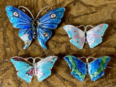 FOUR THOMAS LYSTER MOTT ENAMELLED SILVER BUTTERFLY BROOCHES, including green and blue butterfly