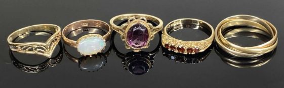FIVE GOLD RINGS, including a garnet five-stone ring, size N, 2.6g; a 9ct gold amethyst dress ring,