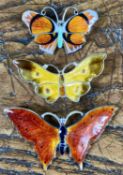 THREE ENAMELLED STERLING SILVER BUTTERFLY BROOCHES, the largest 53mms, 9.9gms, the others 42mm &