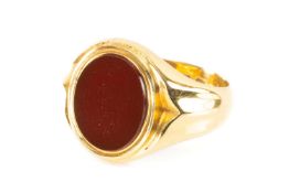 18CT GOLD CARNELIAN SIGNET RING, collet set oval polished stone, shaped shoulders, gross wt. 7.6g,