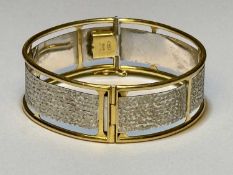 ITALIAN 18CT WHITE & YELLOW GOLD BANGLE, cuff size 58mms, marked '750', 27gms Provenance: private