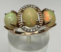 9CT ROSE GOLD THREE-STONE OPAL RING, size N, 2.6g Provenance: private collection Denbighshire