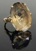 9CT GOLD BOWLED SMOKY QUARTZ DRESS RING, oval cut stone 23 x 17mms, in a cage and six-claw mount,
