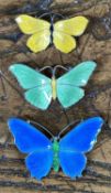 THREE ENAMELLED STERLING SILVER BUTTERFLY BROOCHES, finished in blue, 40mms, green, 37mms and