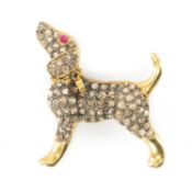 SILVER GILT PUPPY BROOCH, set with rose-cut diamonds, cabochon ruby eye and cabochon emerald collar,
