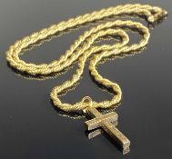 9CT GOLD CROSS FORM PENDANT with chased decoration, suspended from an unmarked rope twist necklace