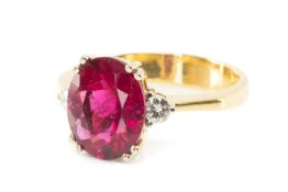 18CT GOLD PRESUMED SPINEL & DIAMOND RING, principal oval cut stone 11 x 9mm, two small diamond