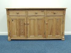 PINE KITCHEN DRESSER BASE, three drawers over triple cupboards with panel doors, turned knob