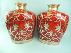 PAIR OF CONTEMPORARY METALLISED VASES, in enamel red with raised silverwork floral design, 37cms (h)
